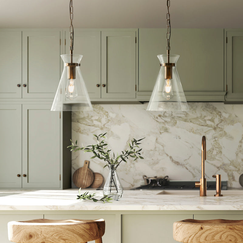 Harlow Pendant in brushed aged brass hanging in a kitchen