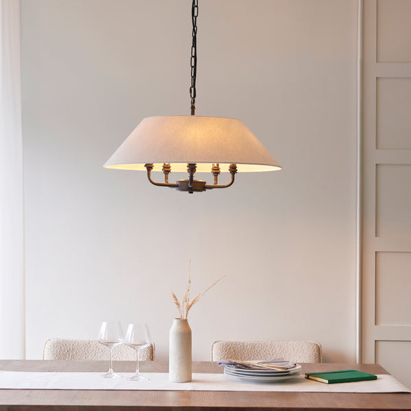Lille 5 Light Pendant in matt black and natural linen hanging in a living room