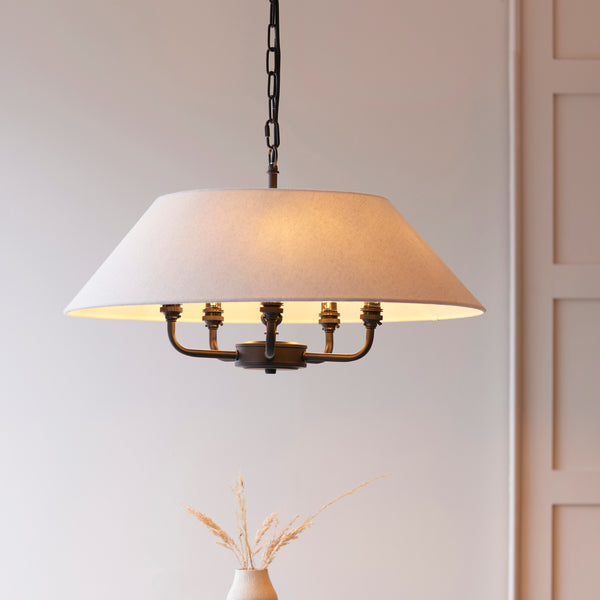 Lille 5 Light Pendant lit up in a styled living room