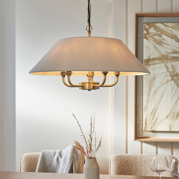 Lille 5 Light Pendant lit up in a styled living room