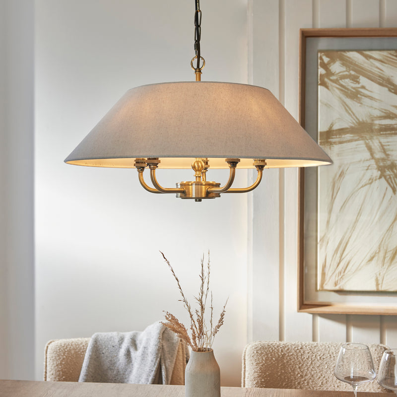 Lille 5 Light Pendant lit up in a styled living room