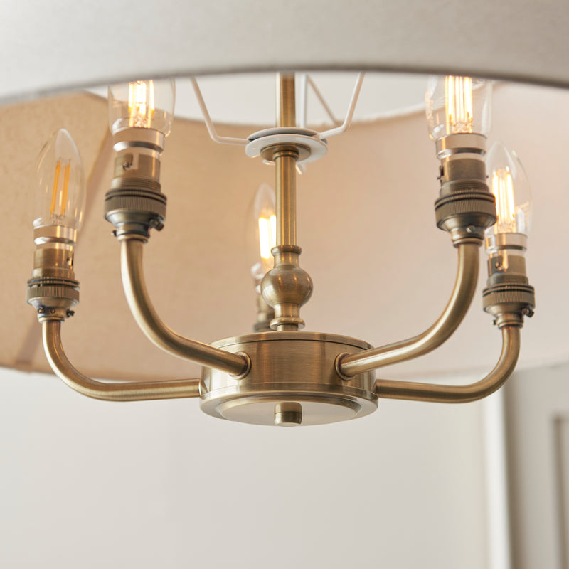 Detail of the antique brass and natural linen finish on the Lille 5 Light Pendant