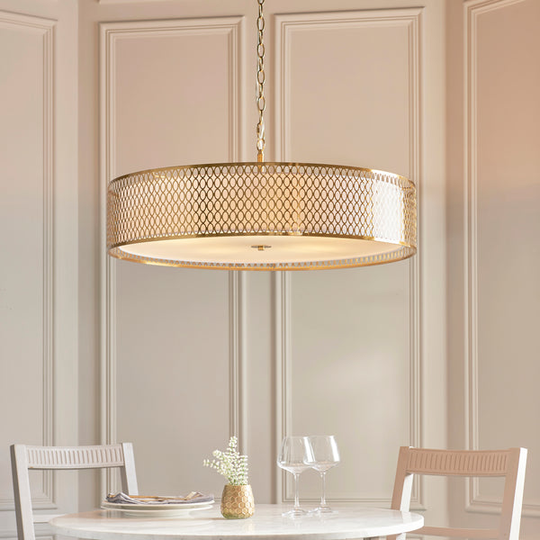 Cordero 5 Light Grand Pendant in gold fretwork hanging in a living room