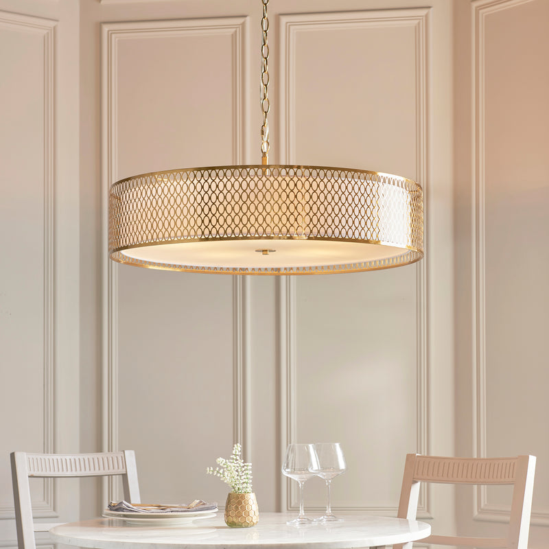 Cordero 5 Light Grand Pendant in gold fretwork hanging in a living room