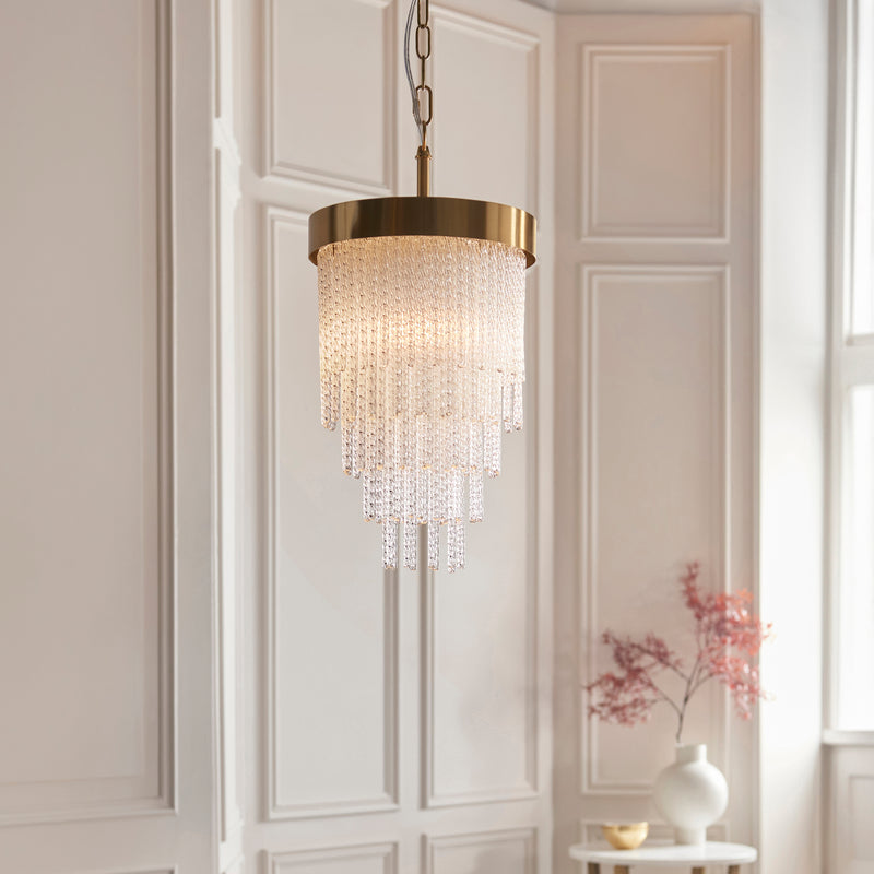 Anistoria Pendant in brushed aged brass shown in a room setting