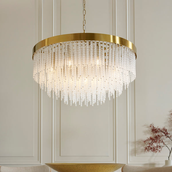 Anistoria Grand 9 Light Chandelier in brushed aged brass shown in a room setting