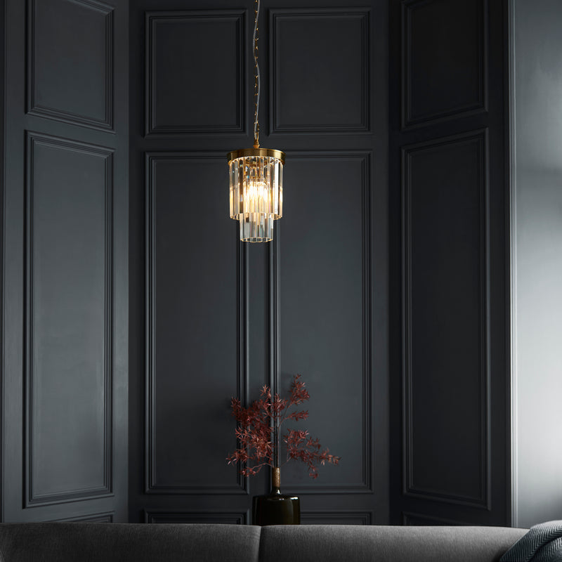 Conaston Pendant in brushed aged brass hanging in a hallway