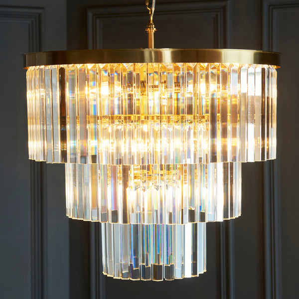 Conaston 7 Light Chandelier in brushed aged brass shown in a room setting