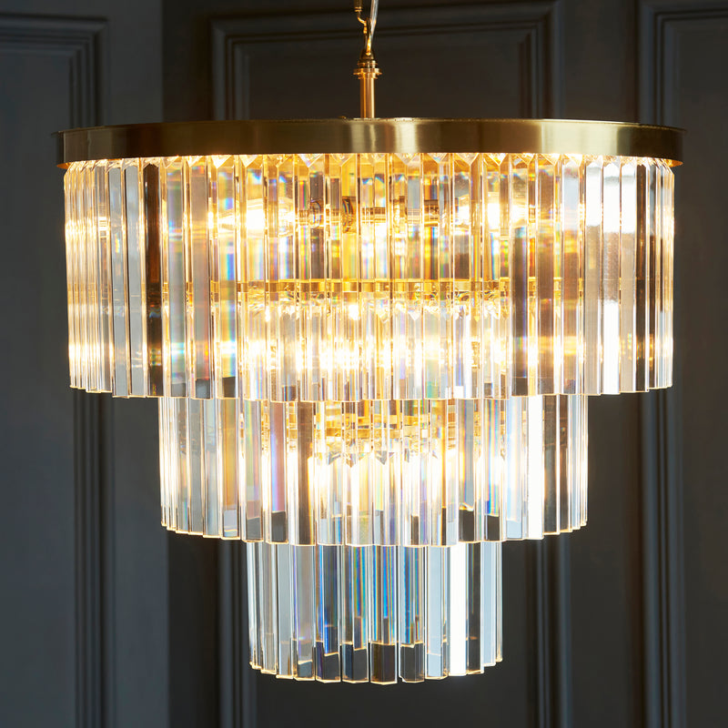 Conaston 7 Light Chandelier in brushed aged brass shown in a room setting