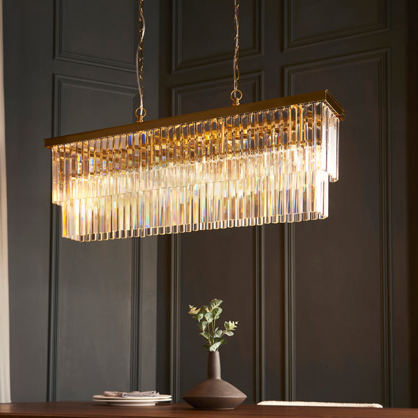 Conaston 4 Light Linear Chandelier in brushed aged brass shown in a room setting