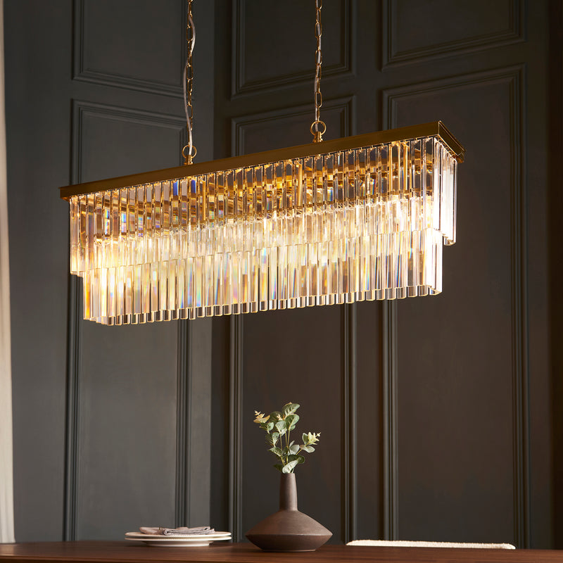 Conaston 4 Light Linear Chandelier in brushed aged brass shown in a room setting