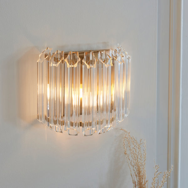 Valentina Wall Light in brushed aged brass on a wall
