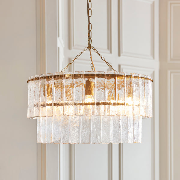 Karine 5 Light Tiered Pendant lit up in a styled living room