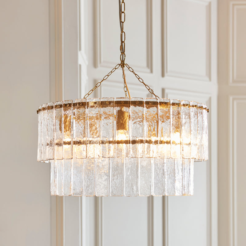 Karine 5 Light Tiered Pendant lit up in a styled living room