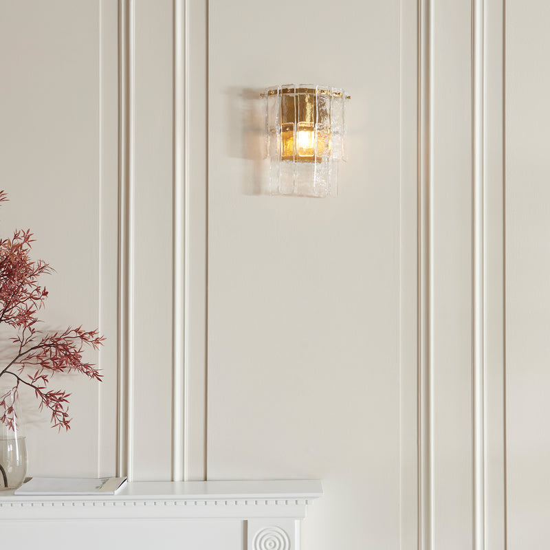 Karine Wall Light in brushed aged brass on a wall