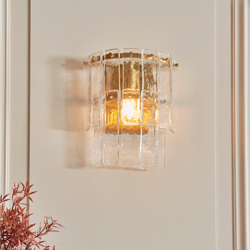 Karine Wall Light lit up in a styled bedroom