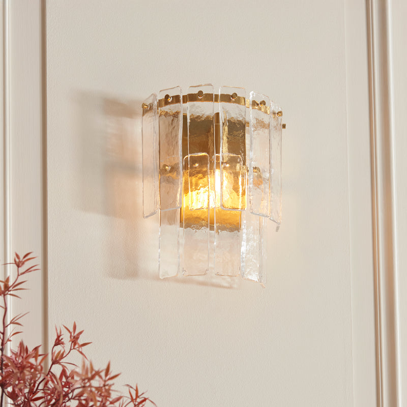 Karine Wall Light in brushed aged brass shown in a room setting
