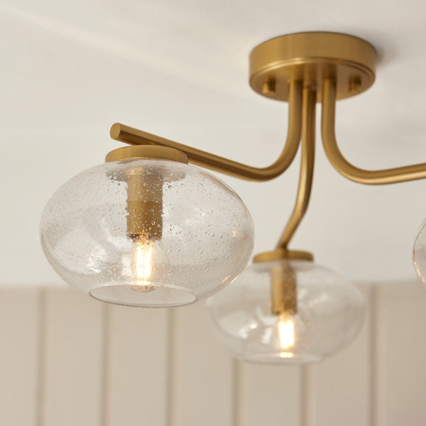 Jacob 3 Light Semi Flush Ceiling Light in warm brass shown in a room setting