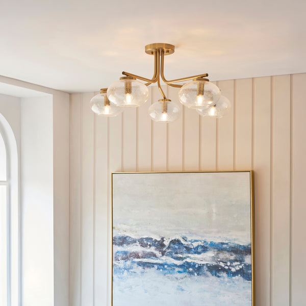 Jacob 5 Light Semi Flush Ceiling Light in warm brass on a living room ceiling