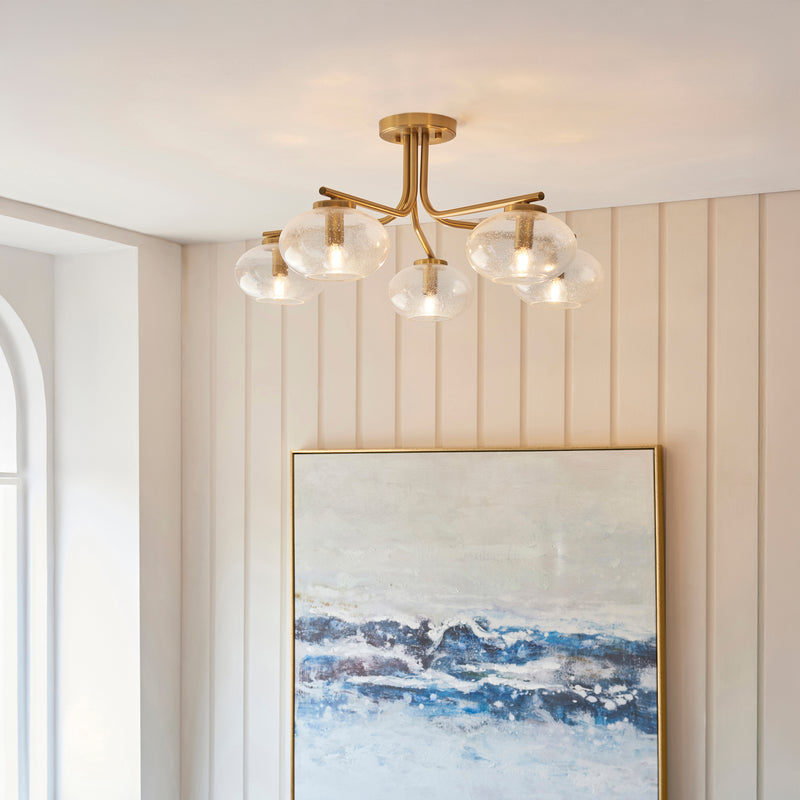 Jacob 5 Light Semi Flush Ceiling Light in warm brass on a living room ceiling