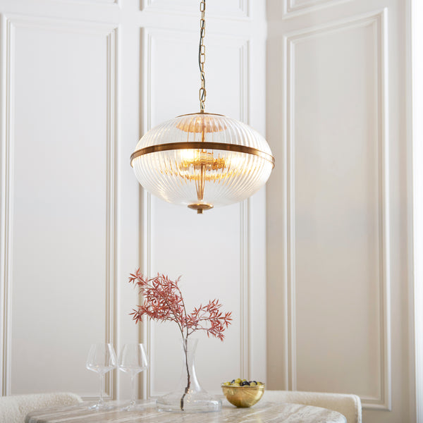 Somerset 3 Light Pendant lit up in a styled living room