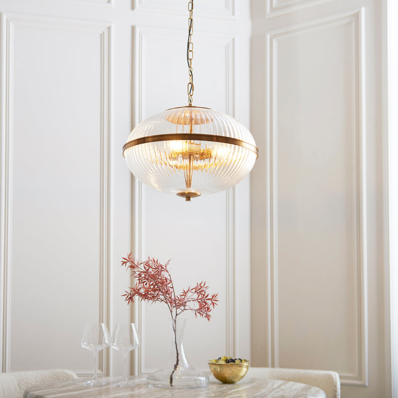 Somerset 3 Light Pendant lit up in a styled living room