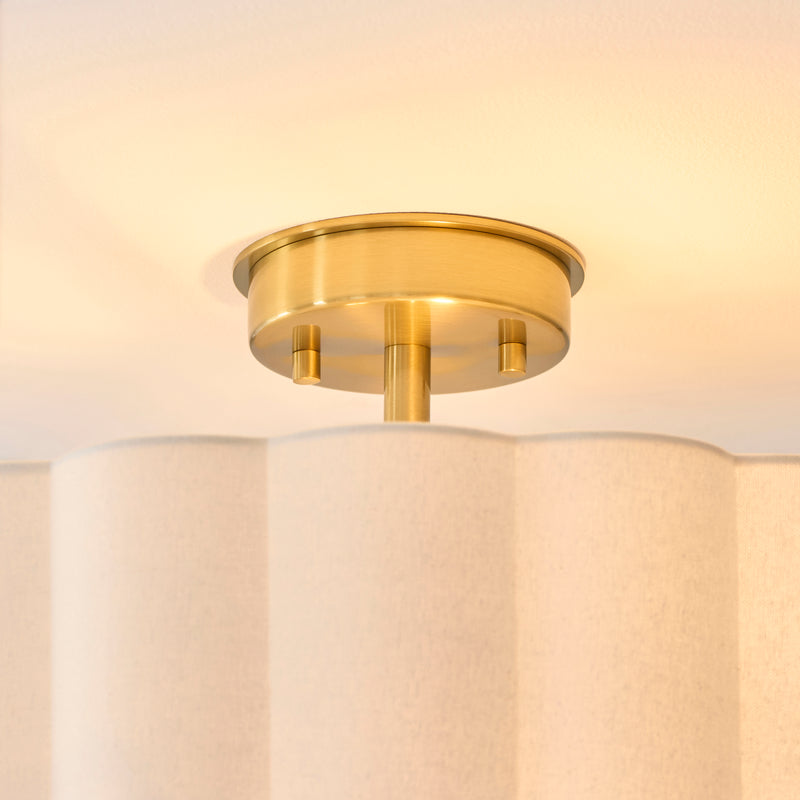 Serene 2 Light Flush Ceiling Light in brushed aged brass shown in a room setting