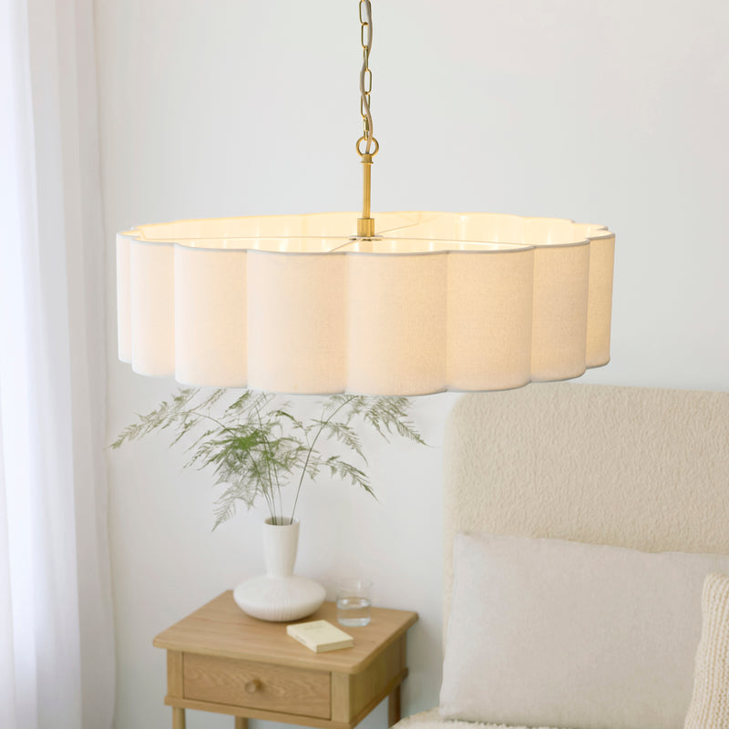 Serene 6 Light Pendant in brushed aged brass shown in a room setting