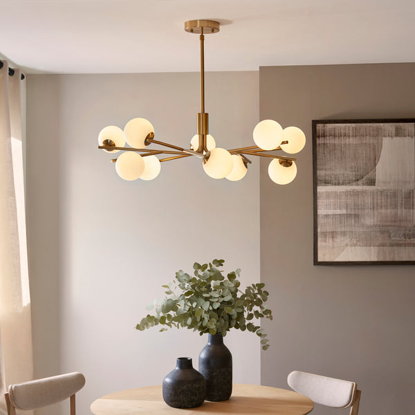 Aaron 10 Light Globe Pendant lit up in a styled living room