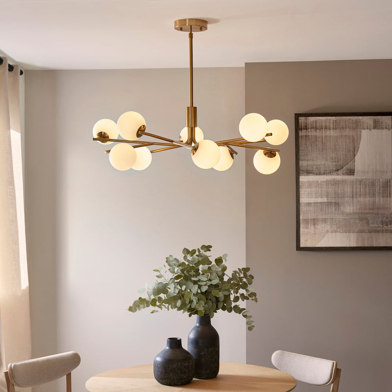 Aaron 10 Light Globe Pendant lit up in a styled living room