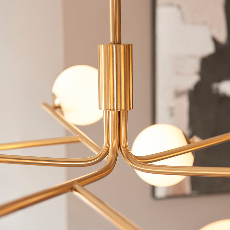 Detail of the brushed aged brass finish on the Aaron 10 Light Globe Pendant