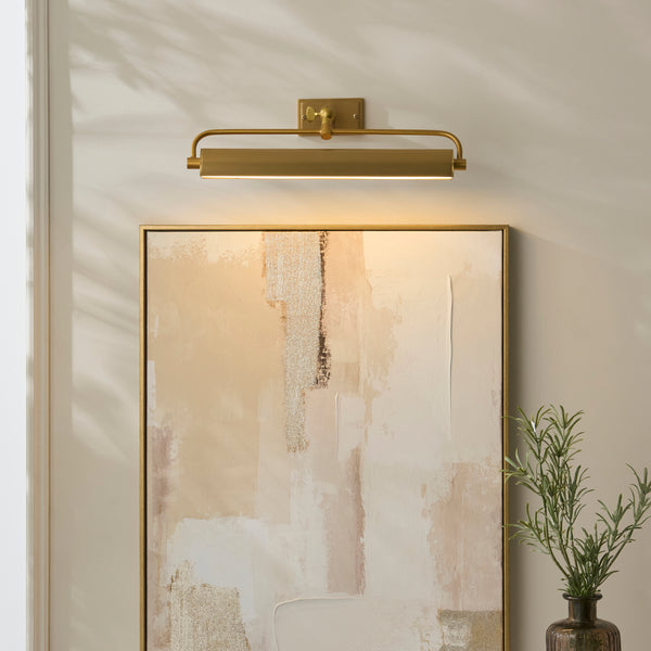 Nantes Rechargeable Picture Light in warm brass on a wall