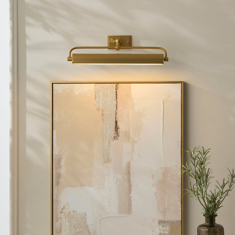 Nantes Rechargeable Picture Light in warm brass on a wall