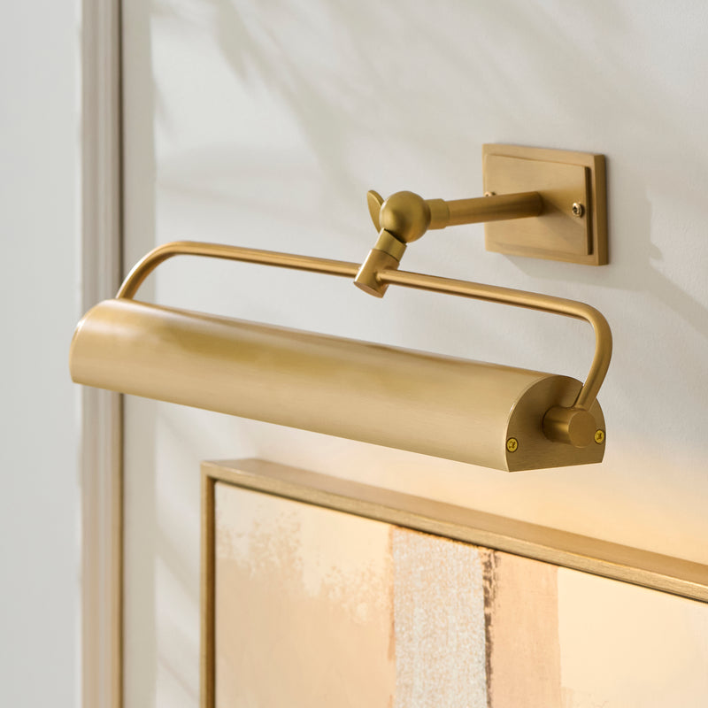 Nantes Rechargeable Picture Light in warm brass shown in a room setting