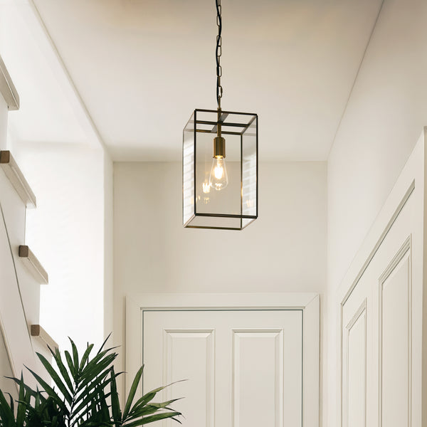 Hammond Grand Lantern Pendant in aged brass hanging in a hallway