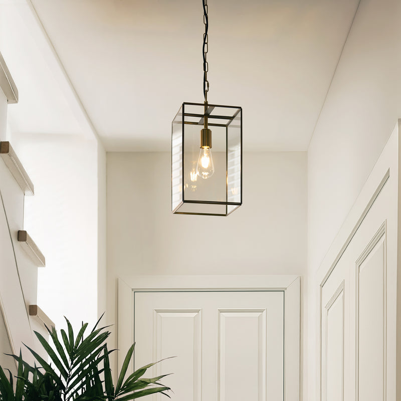 Hammond Grand Lantern Pendant in aged brass hanging in a hallway