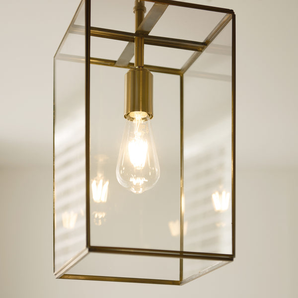 Hammond Grand Lantern Pendant in aged brass shown in a room setting