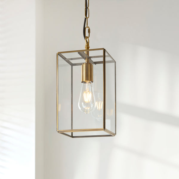 Hammond Lantern Pendant lit up in a styled hallway