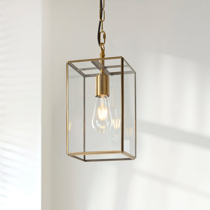 Hammond Lantern Pendant lit up in a styled hallway