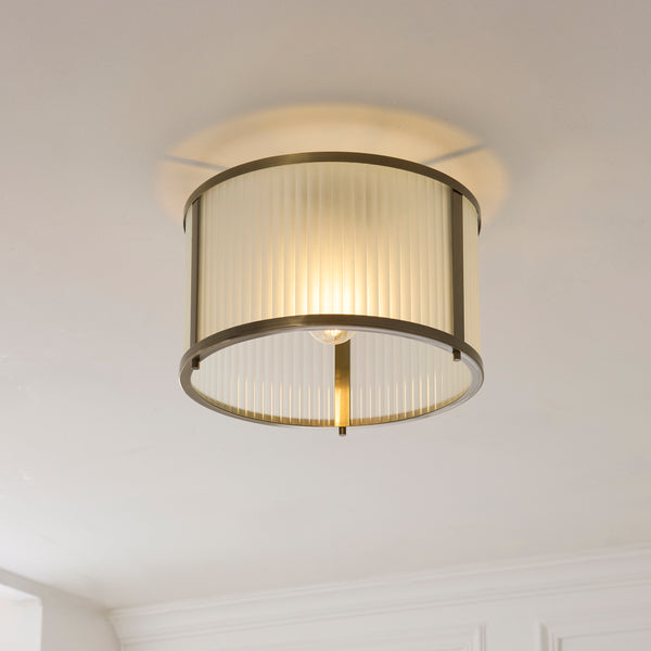 Ridgeton Frosted Flush Ceiling Light lit up in a styled hallway