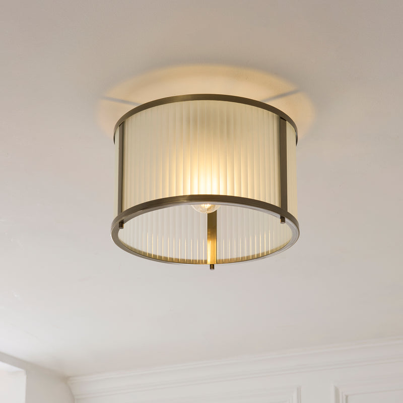 Ridgeton Frosted Flush Ceiling Light lit up in a styled hallway