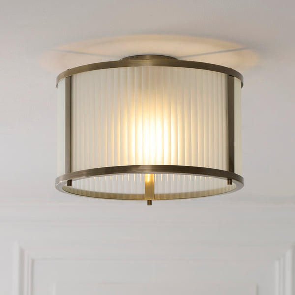 Ridgeton Frosted Flush Ceiling Light in antique brass shown in a room setting