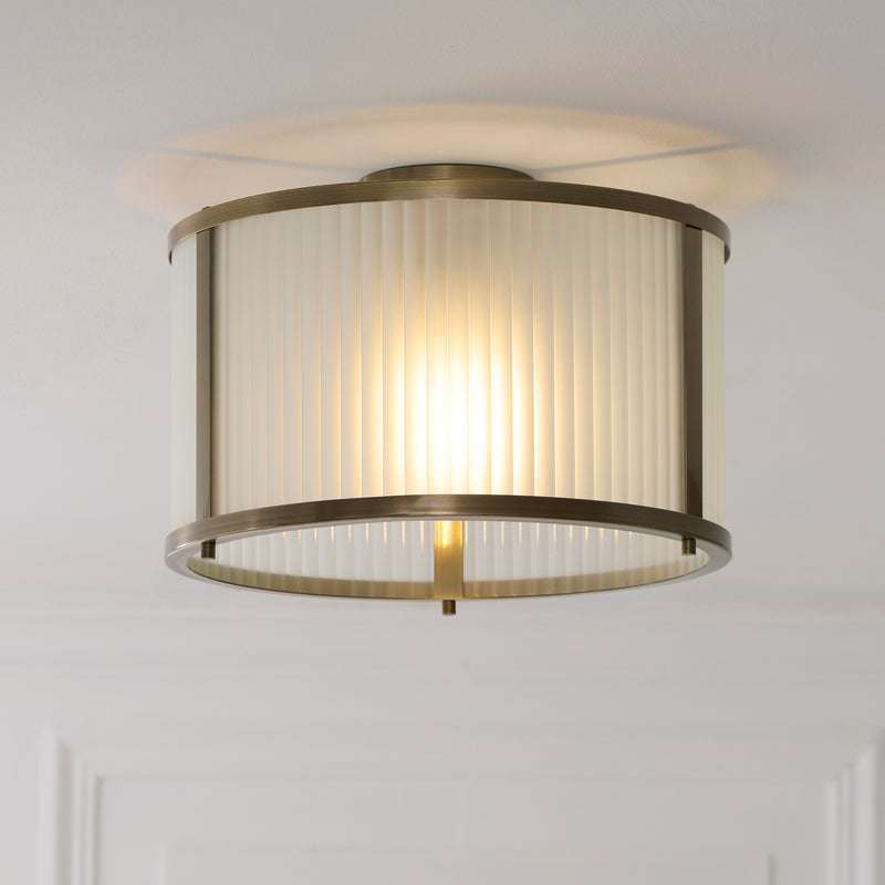 Ridgeton Frosted Flush Ceiling Light in antique brass shown in a room setting