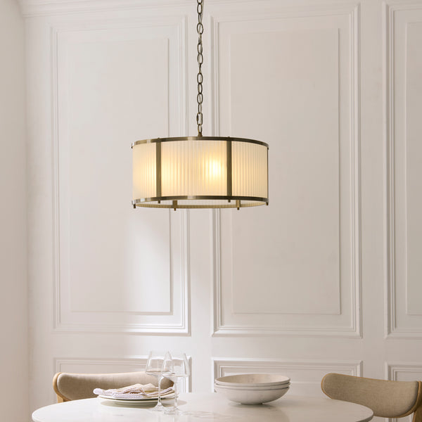Ridgeton Frosted 3 Light Pendant in antique brass hanging in a hallway
