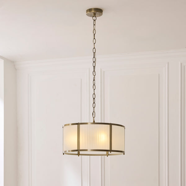Ridgeton Frosted 3 Light Pendant lit up in a styled hallway