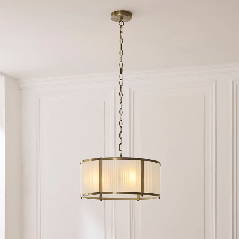 Ridgeton Frosted 3 Light Pendant lit up in a styled hallway