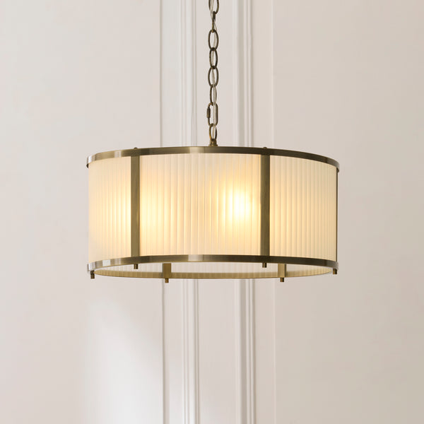 Ridgeton Frosted 3 Light Pendant in antique brass shown in a room setting