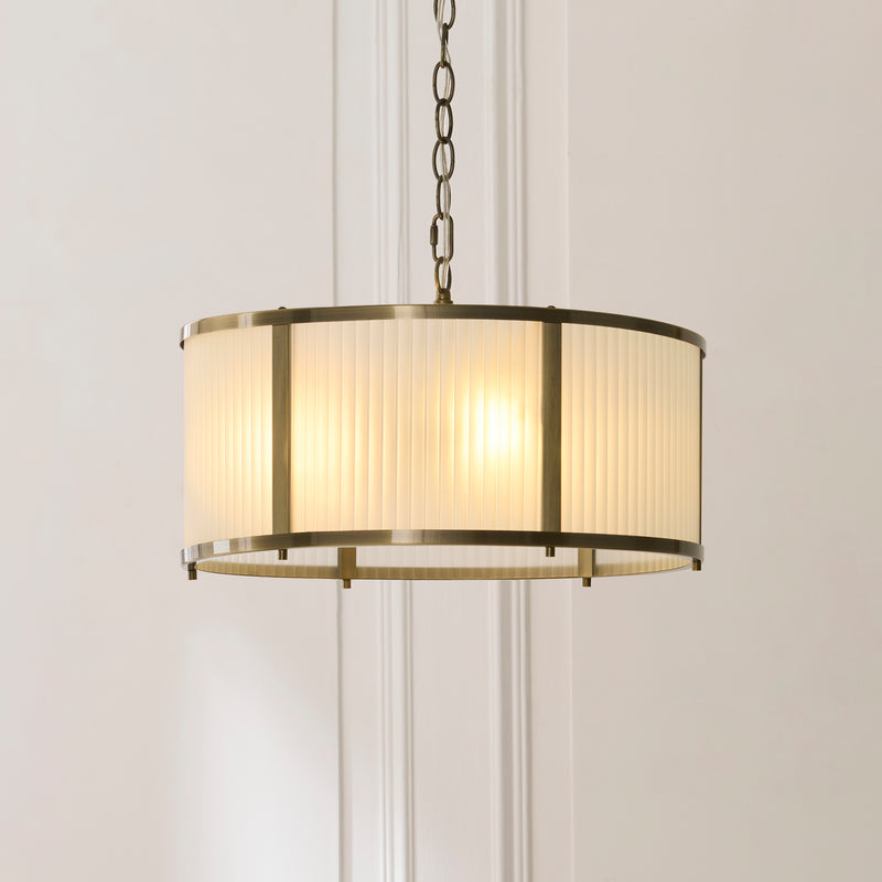 Ridgeton Frosted 3 Light Pendant in antique brass shown in a room setting