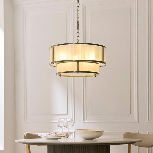 Ridgeton Frosted 5 Light Tiered Pendant in antique brass hanging in a hallway