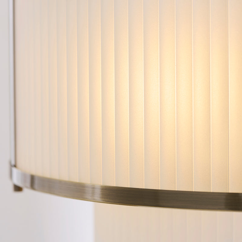 Detail of the antique brass finish on the Ridgeton Frosted 5 Light Tiered Pendant